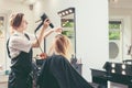 Beautician blow dry woman`s hair at beauty salon