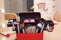 Beautician case with professional makeup products and tools on dressing table Royalty Free Stock Photo