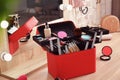 Beautician case with professional makeup products and tools on dressing table Royalty Free Stock Photo