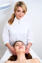 Beautician cleaning woman`s face. Spa skincare treatment. Cosmetologist with patient on medical chair. Healthy skin Royalty Free Stock Photo