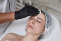 beautician cleanses skin of woman with cotton sponge. . Royalty Free Stock Photo