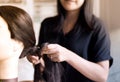 Beautician close up of a hairdresser braiding her clients