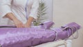 Beautician controls procedure of pressotherapy