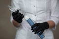 beautician doctor in black gloves holds darsonval tips