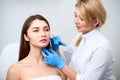 Beautician doctor with botulinum toxin syringe making injection to to remove crow`s feet. Cheek volume enhance Royalty Free Stock Photo