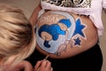 Bodypaint on a pregnant woman's belly