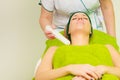 Beautician doing ultrasound cavitation peeling on woman
