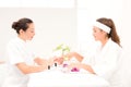 Beautician filing female clients nails at spa beauty salon Royalty Free Stock Photo