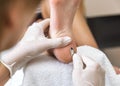 Beautician foot treatment.Treatment of feet and nails. Royalty Free Stock Photo