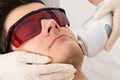 Beautician Giving Laser Epilation Treatment To Man Face Royalty Free Stock Photo