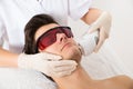 Beautician Giving Laser Epilation Treatment To Man Face Royalty Free Stock Photo