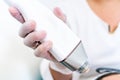 Beautician holding radio frequency microneedling hand piece. Used for skin tightening and cosmetic treatments in spas, salons and Royalty Free Stock Photo