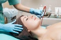 Beautician makes mechanical cleaning of face. Procedure of Microdermabrasion, diamond grinding. Royalty Free Stock Photo