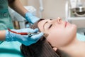 Beautician makes mechanical cleaning of face. Procedure of Microdermabrasion, diamond grinding. Royalty Free Stock Photo