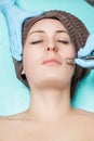 Beautician makes mechanical cleaning of face. Procedure of Microdermabrasion, diamond grinding. Royalty Free Stock Photo