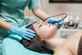 Beautician makes mechanical cleaning of face. Procedure of Microdermabrasion, diamond grinding. Royalty Free Stock Photo