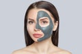 Beautician makes a mud mask to cleanse the skin and anti-wrinkle on the face of a beautiful woman, spa treatments and cosmetology Royalty Free Stock Photo