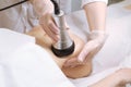 Beautician makes the procedure cavitation of a young beautiful girl. The concept of skin care face and body