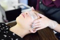 Beautician making eyelash lamination procedures. Modern eyelash care treatment procedures - staining, curling, laminating and
