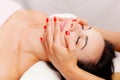 Beautician massaging woman`s face. Attractive girl having facial treatment and massage. The young woman is lying and relaxingin Royalty Free Stock Photo