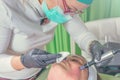 Beautician performs a needle mesotherapy treatment on a woman face Royalty Free Stock Photo