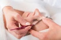 Beautician plucking eyebrows with tweezers of a woman