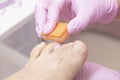 Beautician polishing nails, pedicure. Foot care treatment and nail, Royalty Free Stock Photo