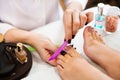 Beautician polishing nails, pedicure. Foot care treatment and na Royalty Free Stock Photo