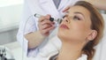 Beautician uses iontophoresis roller for client`s face