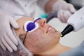 Beautician uses laser for epilate patient face in