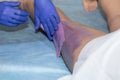 Beautician Waxing Leg Of Woman With Wax Strip At Beauty Clinic Royalty Free Stock Photo