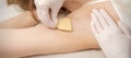 Beautician waxing young female armpit Royalty Free Stock Photo