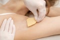 Beautician waxing young female armpit Royalty Free Stock Photo