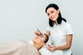 Beautician working during eyelash extension procedure