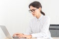 Beautif; caucasian businesswoman working on laptop typing in modern home office. Smart businesswomen happy smiling on her work