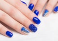 Beautifil blue manicure with rhinestone. Nail Design. Close-up