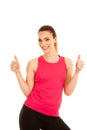 Beautifil young sporty woman shows thumb up as a gesture fo success isolated over white background Royalty Free Stock Photo