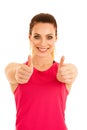 Beautifil young sporty woman shows thumb up as a gesture fo success isolated over white background Royalty Free Stock Photo