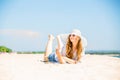 Beautifil young woman lying on the beach at sunny