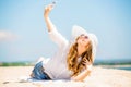 Beautifil young woman lying on the beach at sunny