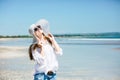 Beautifil young woman walking along the beach at