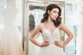 Beautifu bride choosing wedding dress in a wedding salon Royalty Free Stock Photo