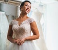 Beautifu bride choosing wedding dress in a wedding salon Royalty Free Stock Photo