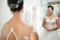 Beautifu bride choosing wedding dress in a wedding salon Royalty Free Stock Photo