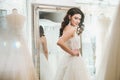 Beautifu bride choosing wedding dress in a wedding salon Royalty Free Stock Photo