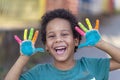 Beautifu happy boy with colorful painted hands Royalty Free Stock Photo