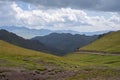 Beautifu lview of green mountains with dangerous gravel road. Ketmen or Ketpen mountains gorge and mountain pass.