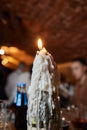 Beautiful ablaze candle on the wooden table. Royalty Free Stock Photo