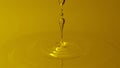 Beautiful abstract background with drops of sunflower oil or honey flowing falling dripping