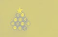 A beautiful abstract Christmas tree made of Christmas balls and a gold star on a gray background. Demonstrating trendy colors 2021 Royalty Free Stock Photo